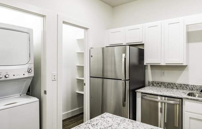 a kitchen with granite countertops and stainless steel appliances