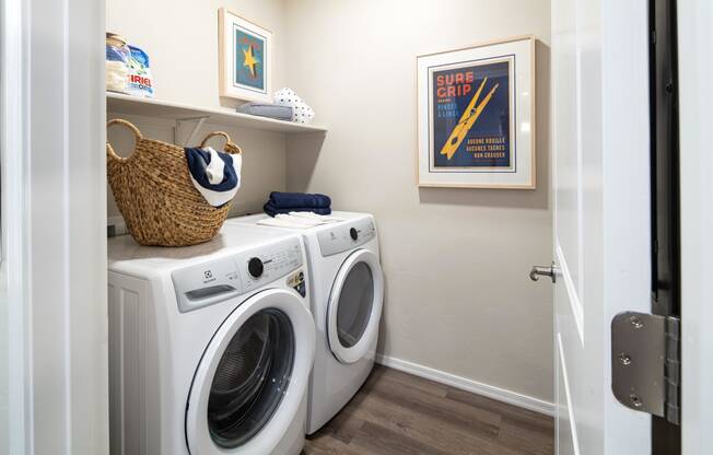 a washer and dryer in a laundry room with a white door