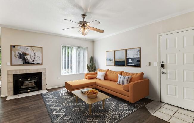 a living room with a couch and a ceiling fan