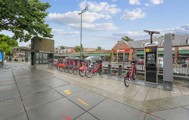 A row of bikes are parked at a bike station.