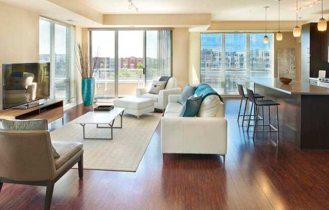 A living room with a white couch and a television.