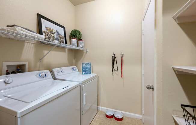a washer and dryer in a laundry room with a door to the bathroom