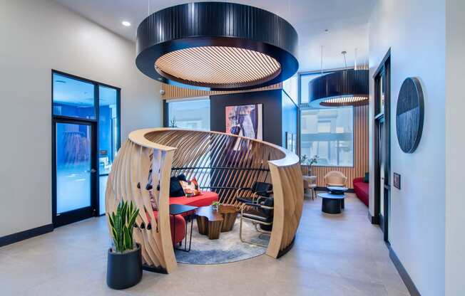 a living room with a wooden spiral staircase and a table and chairs