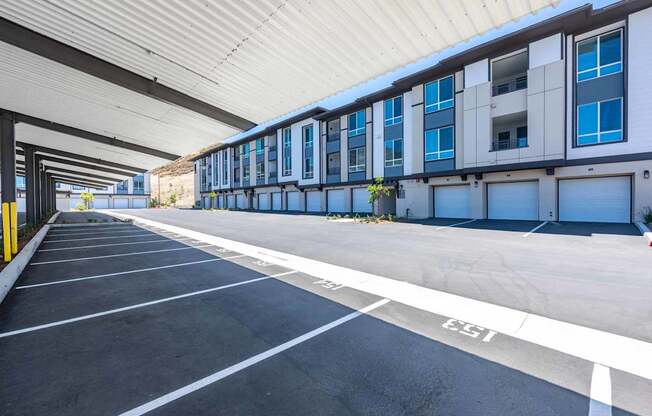 A parking garage with a long row of parking spaces.