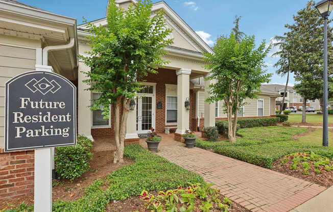 A sign that says "Future Resident Parking" stands in front of a house.
