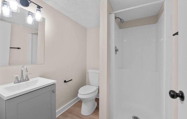 A white sink and toilet in a small bathroom.