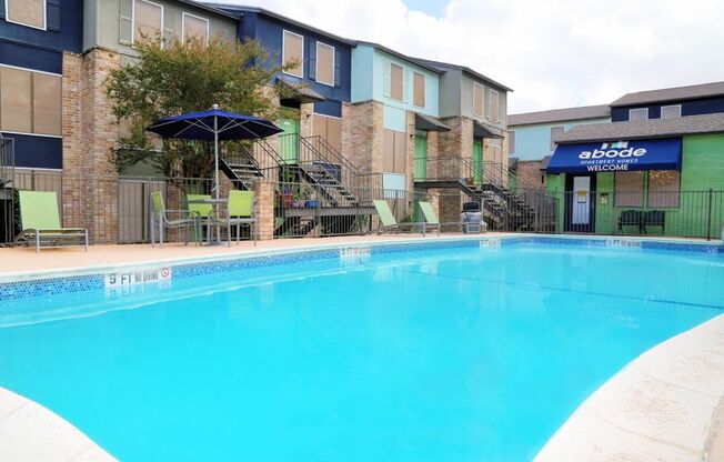 a large swimming pool with a building in the background