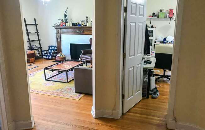 A room with a fireplace and a chair.