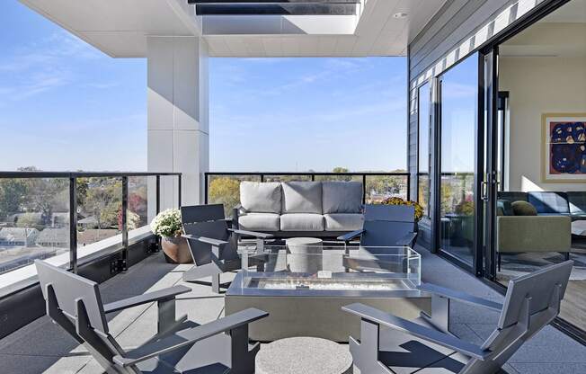 A modern outdoor seating area with a table and chairs.