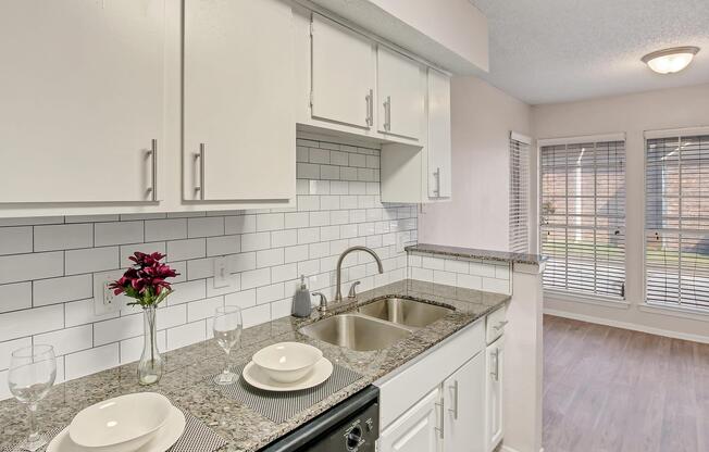 a kitchen with a sink and a mirror