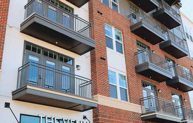 The Venue on South Main is a multi-story apartment building with balconies and large windows.