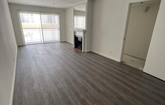 Living Room with Hardwood Floors, Fireplace and Patio Door