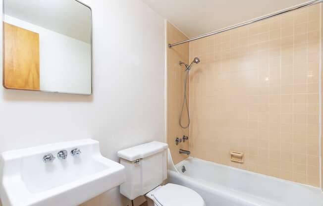 a bathroom with a sink toilet and a bath tub