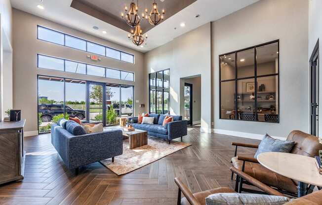 A living room with a grey couch and a wooden floor.