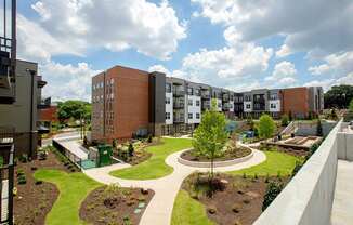 A view of a courtyard with a tree and a circular walkway.