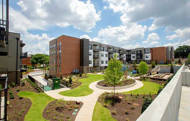 A view of a courtyard with a tree and a circular walkway.