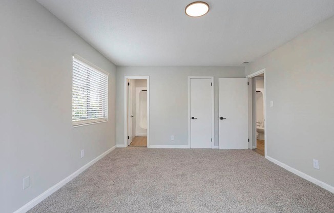 A room with white walls and a carpeted floor.
