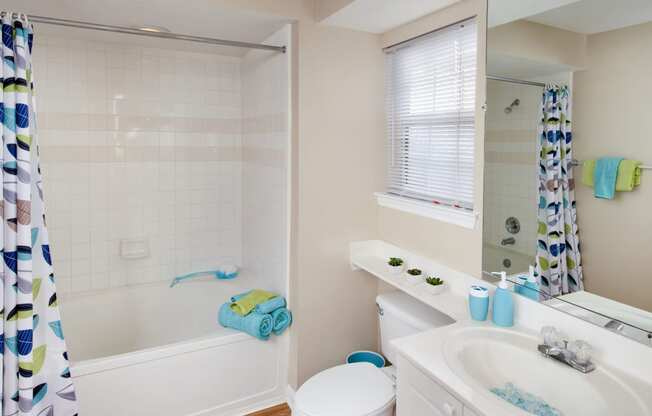 a bathroom with a toilet and a tub and a sink