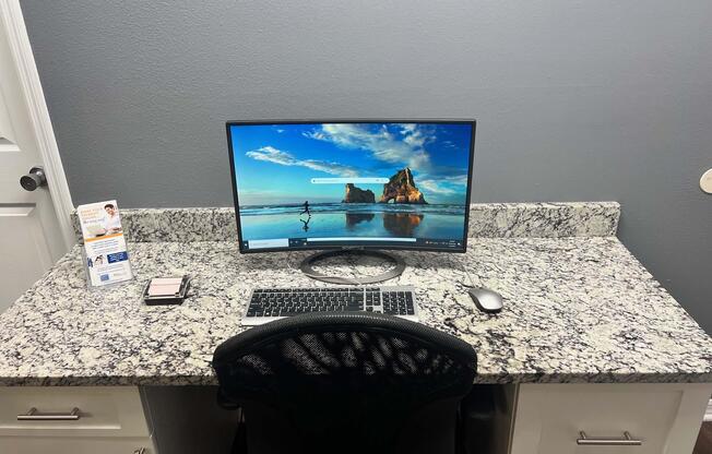a desk with a computer on a table