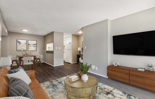 A living room with a brown couch and a coffee table.
