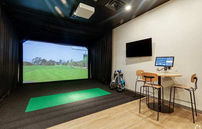A room with a green mat on the floor and a bike leaning against the wall.