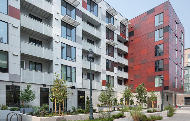 A modern building with a red and grey facade. at Ravello Apartments, Washington, 98052