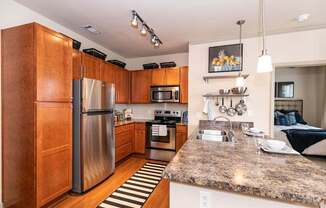 A kitchen with wooden cabinets and granite countertops.