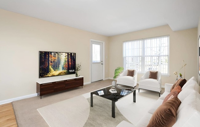 a living room with a couch and a coffee table at West Pointe Apartments in Burlington, NC