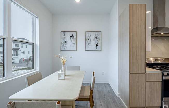 A dining room with a table and chairs.