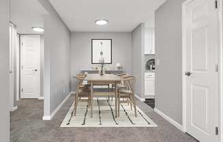 Model Dining Room with Carpet and View of Kitchen at Stone Ends Apartments in Stoughton, MA.