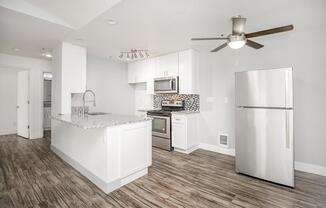 a kitchen with a sink and a refrigerator