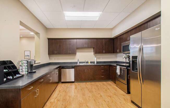 Kitchen with cherry oak cabinets and light wooden floors.