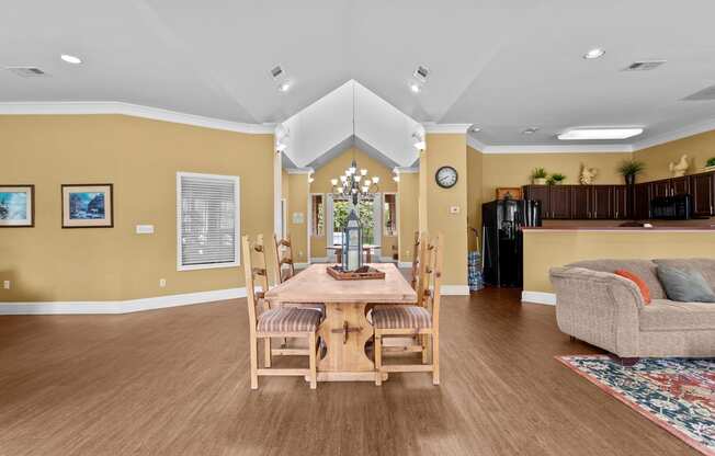 a dining room with a wooden table and chairs