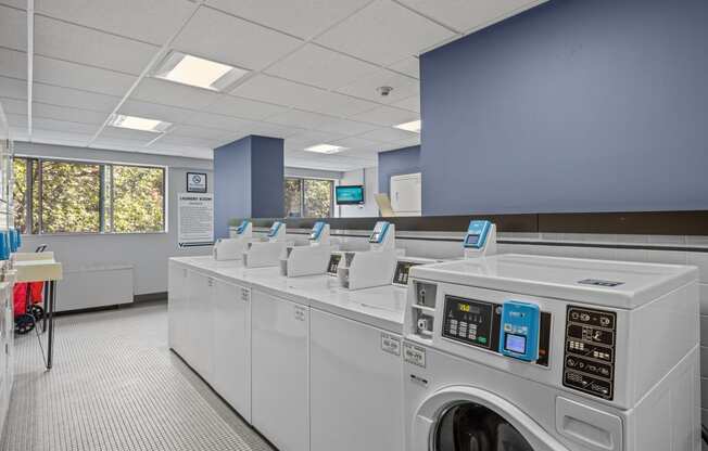 a laundry room with washers and dryers