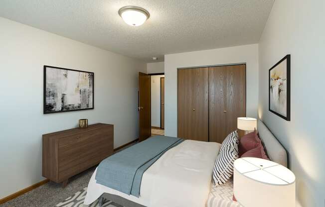 Fargo, ND Parkside Apartments. A bedroom with a bed and a dresser