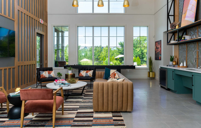 a living room filled with furniture and a large window