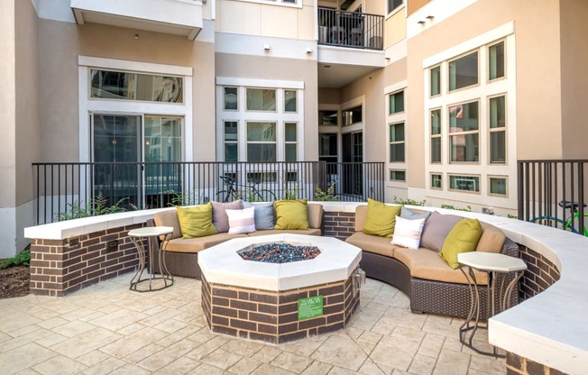 an outdoor patio with furniture and a fire pit