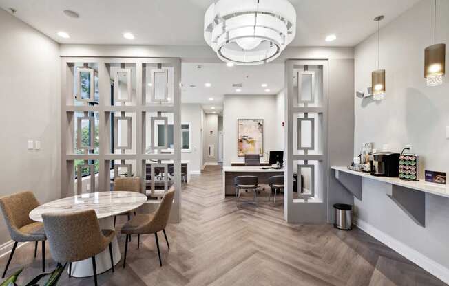 A modern dining room with a round table and chairs.