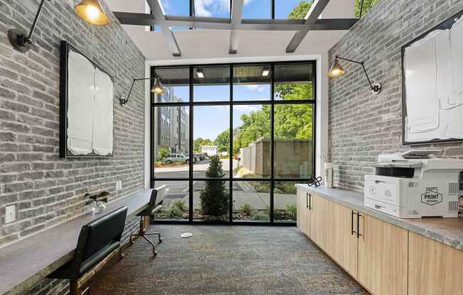 A room with a brick wall and a glass door leading outside.