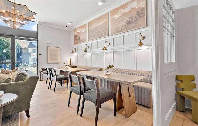 A dining room with a long table and chairs.