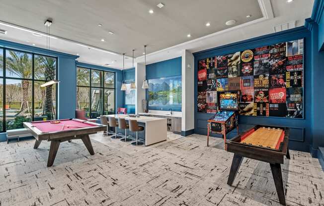 a game room with pool tables and a wall covered in posters at Altis Grand Suncoast, Florida, 34638