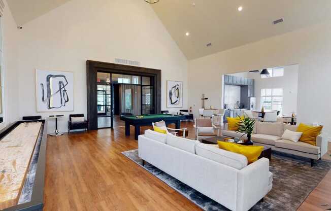 a living room with a couch and a pool table at The Fitzroy San Marcos, San Marcos, TX