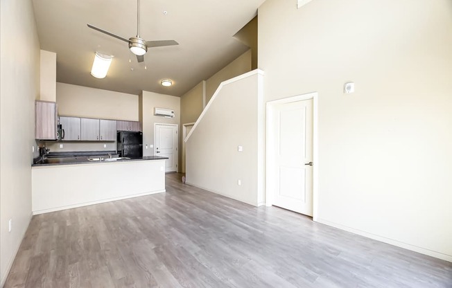 A spacious kitchen with a fan on the ceiling.
