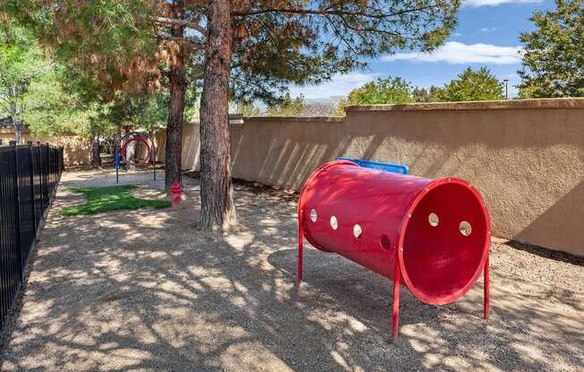 Fenced dog park with agility equipment at Reserve at Rancho Apartments