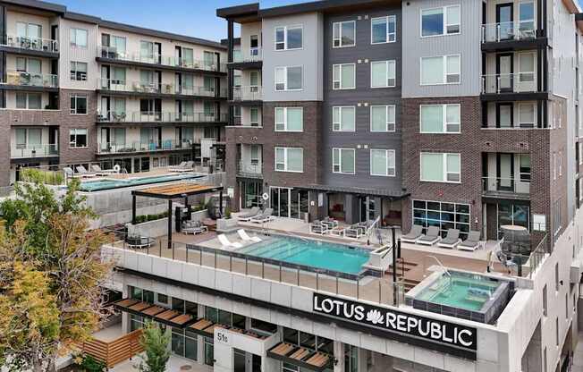 A large apartment complex with a pool and the words