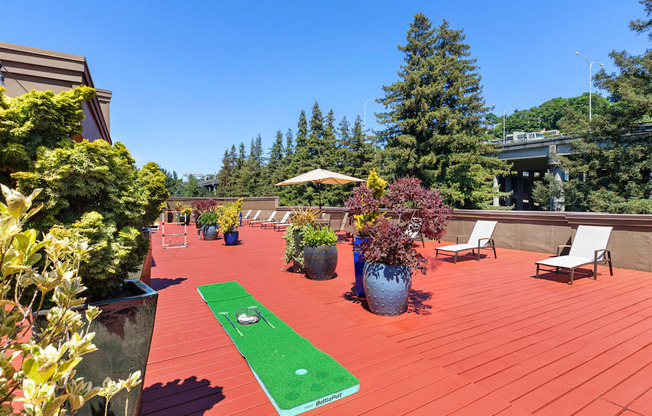 a mini putting green on the resident rooftop deck with trees in the background at Illumina Apartment Homes, Seattle, Washington 98102