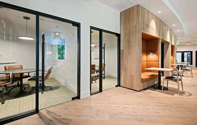 A modern office space with glass walls and wooden accents.