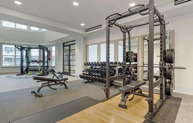 a workout room with weights and other exercise equipment at trillium apartments in fairfax,