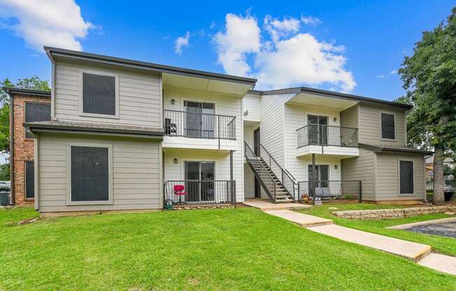 A two-story residential building with a balcony on the second floor.