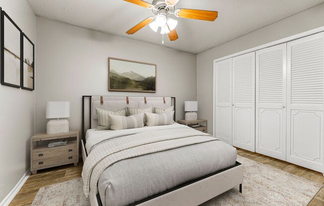 a bedroom with a bed and a ceiling fan